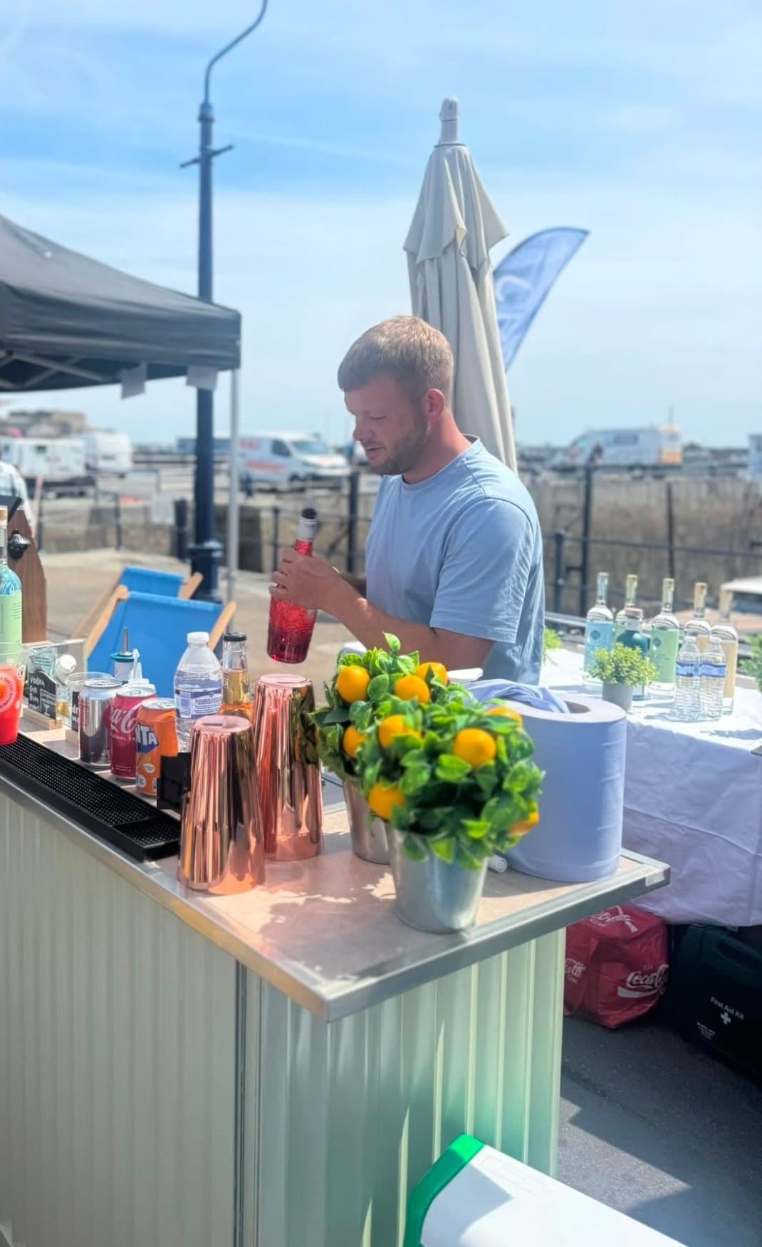 Our bar manager pouring a drink at The Dirty Olive mobile bar on Guernsey’s harbour front